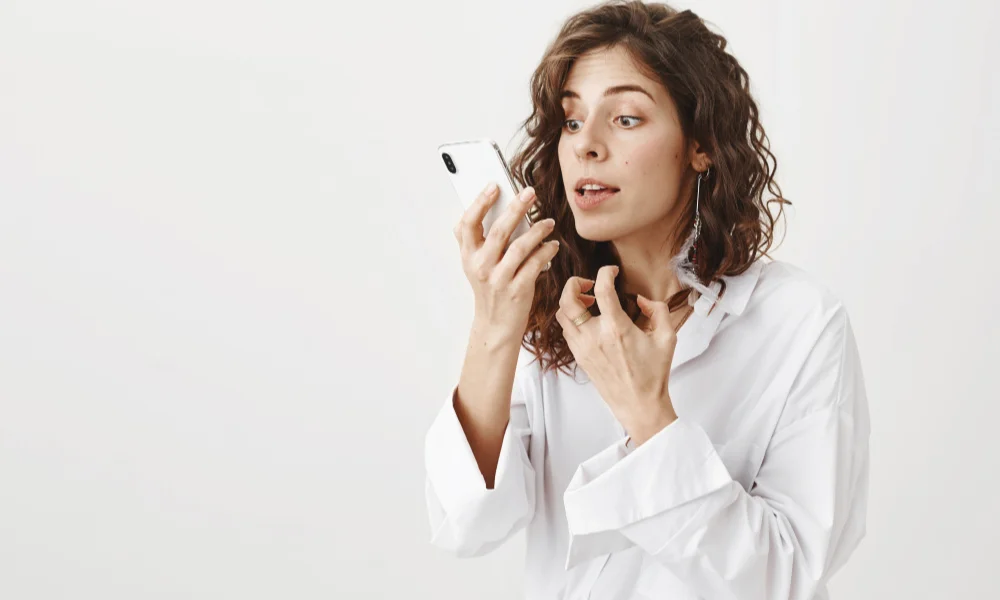 Woman with curly hair in a white blouse
