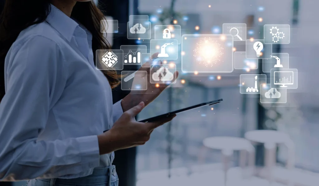 Woman holding a tablet displaying various colorful icons on the screen, engaged in digital interaction.