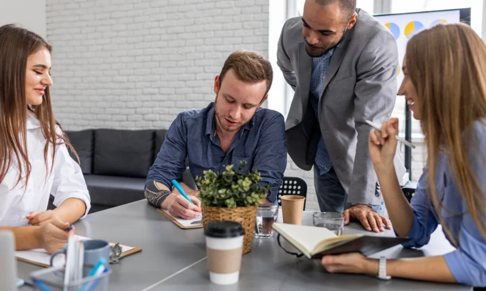 A diverse group of four people is collaborating-build brand trust