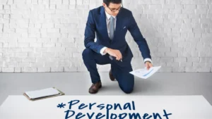 man in a navy suit kneels on the floor