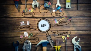 A wooden desk with scattered tools and a central magnifying glass labeled "SEO."